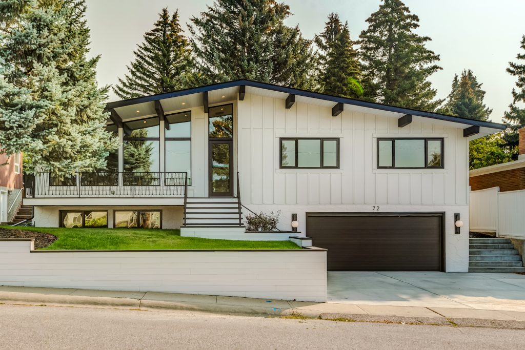 A renovated home exterior with black roof beams.