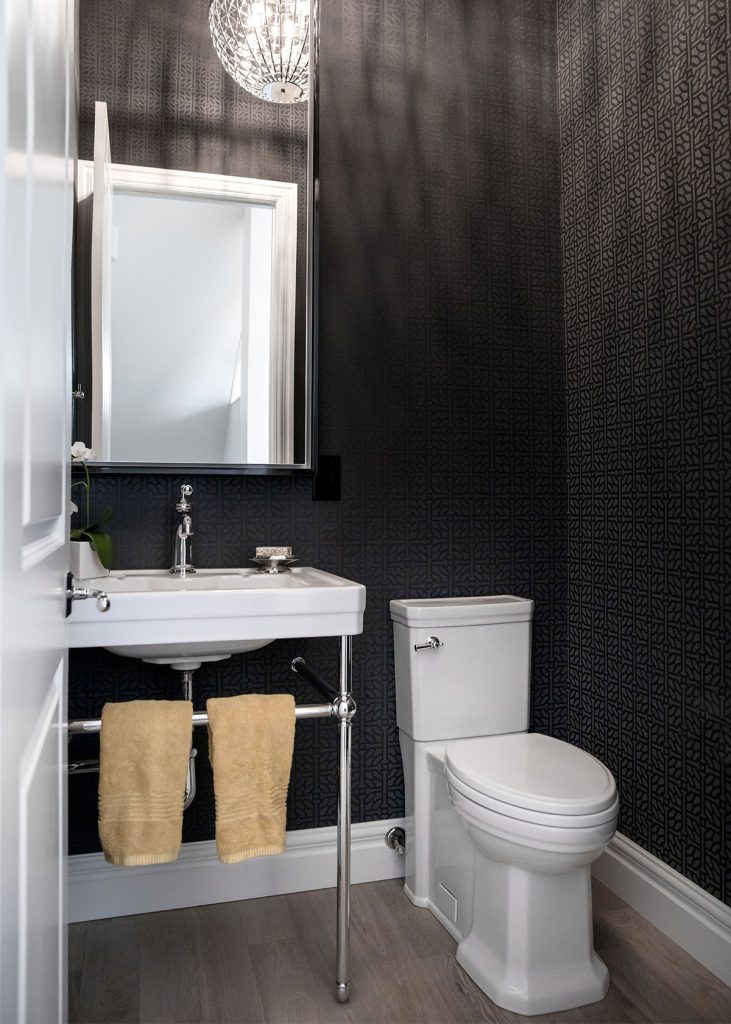 A newly renovated designer guest bathroom with dark brown wallpaper.