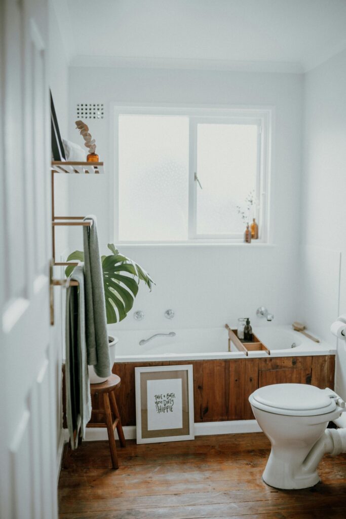 Scandinavian bathroom with wood paneling on bathtub