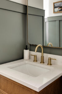 Modern bathroom sink with gold faucet