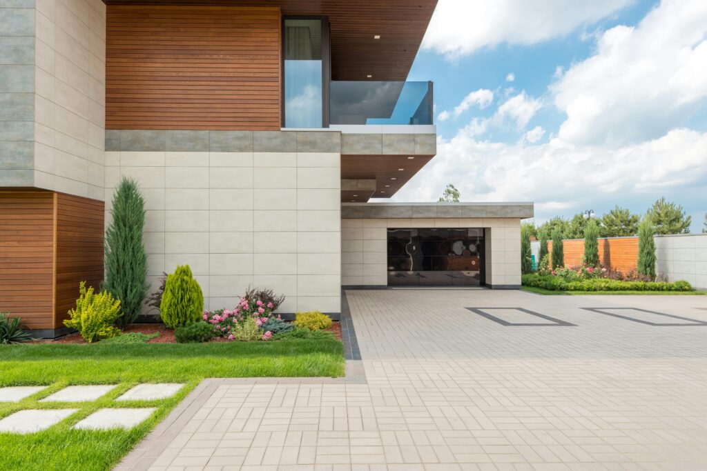 Large modern home driveway with paver stones