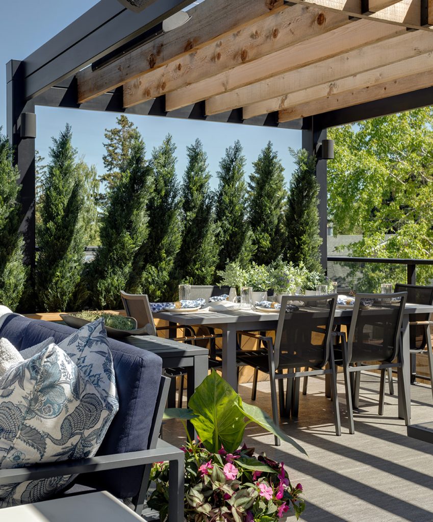 A deck with an elegant dining area under a new purgola.