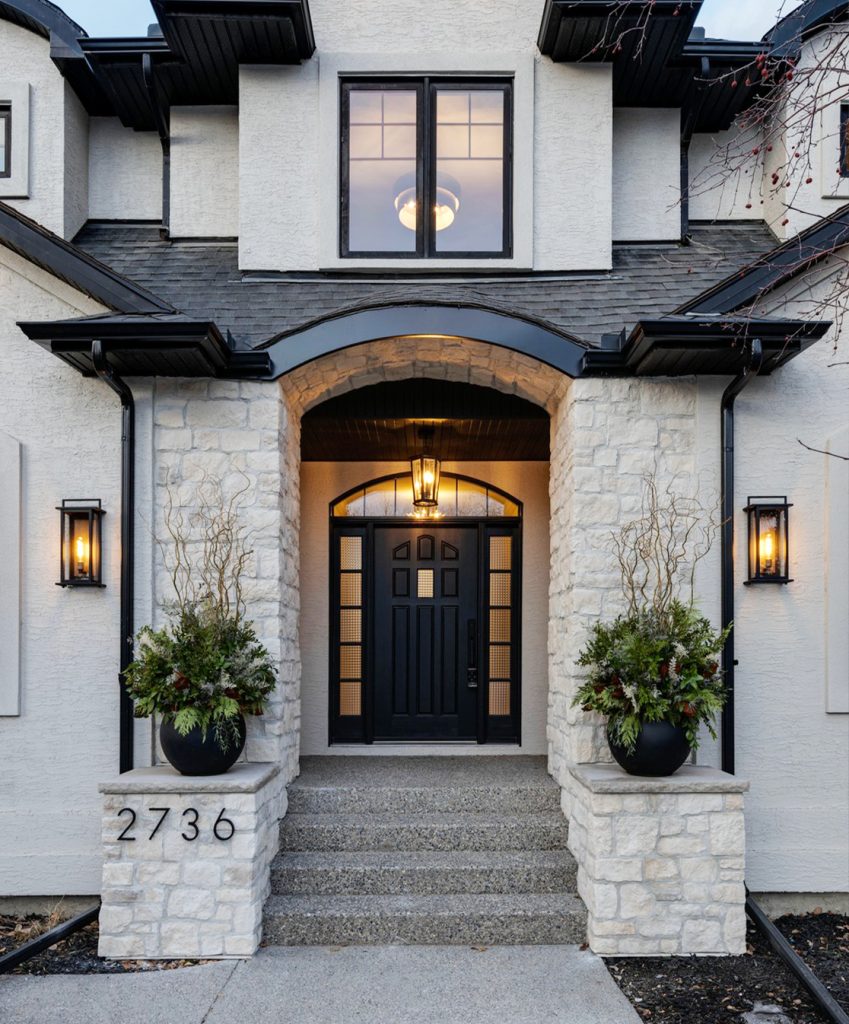 An exterior of a newly renovated home with modern outdoor lights.