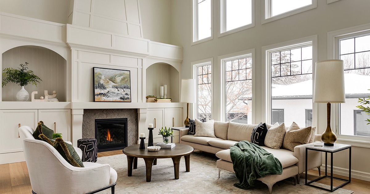 A newly renovated living room with larger windows and a high ceiling.