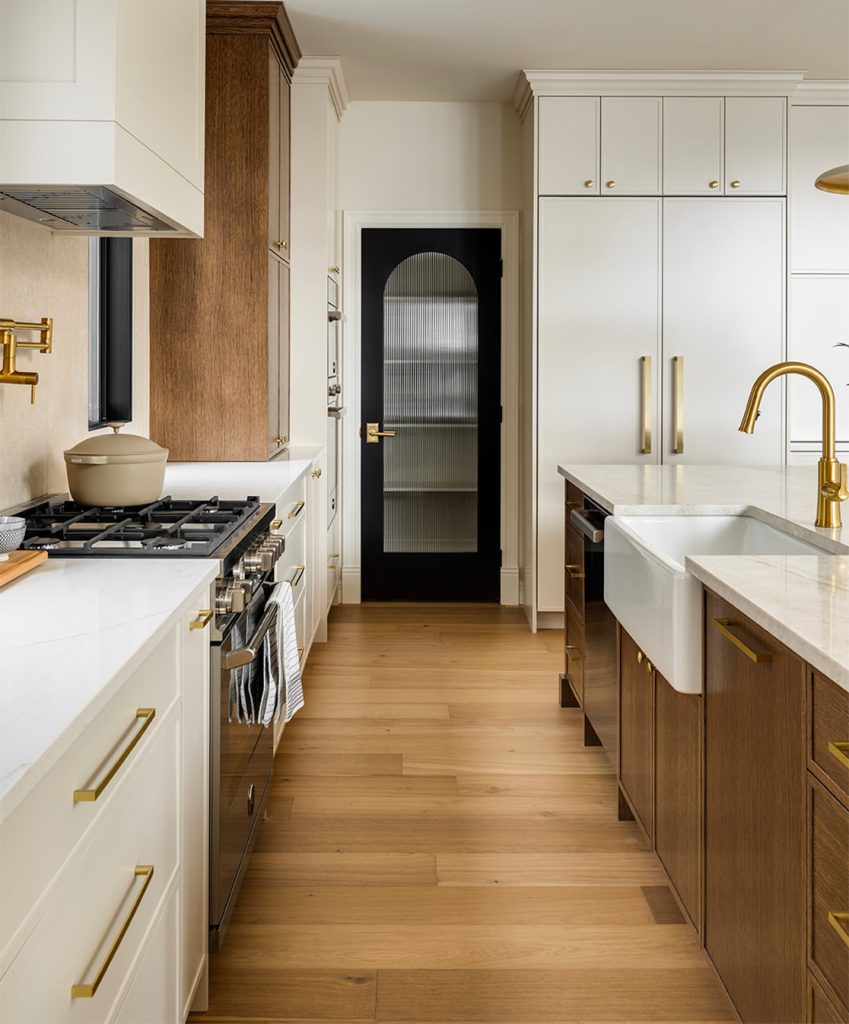 A new kitchen with a modern black glass pantry door.
