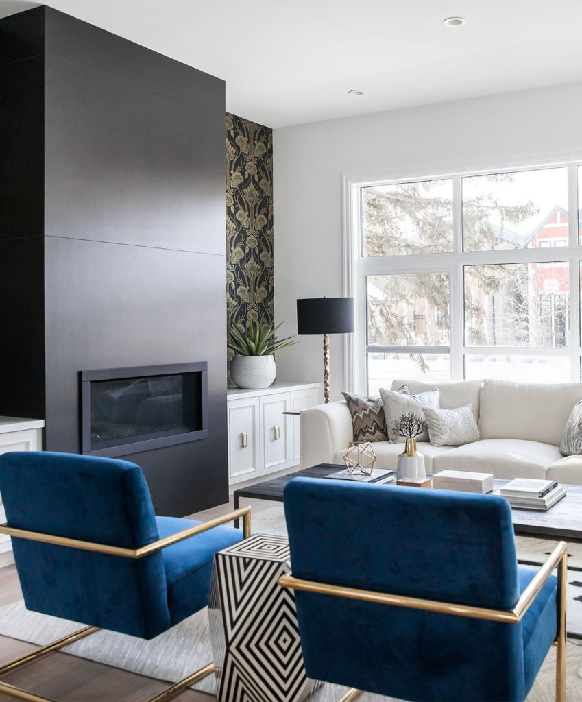 A modern living room featuring square velour brilliant blue chairs.