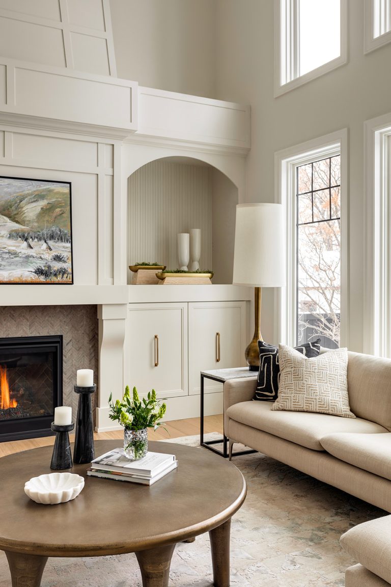 A newly renovated off-white living room with a double-height ceiling.