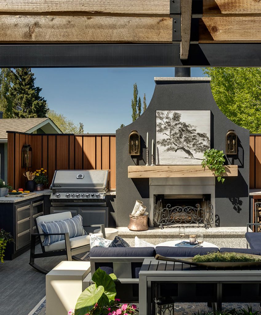 A unique patio designed around a large ornate outdoor fireplace.