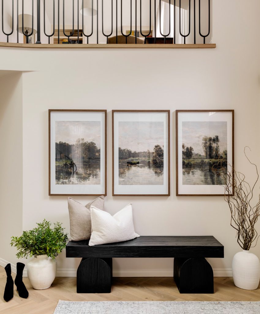 A newly renovated front entrance of a home with 3 pieces of art.