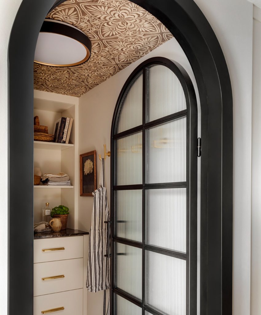 Arched black pantry door
