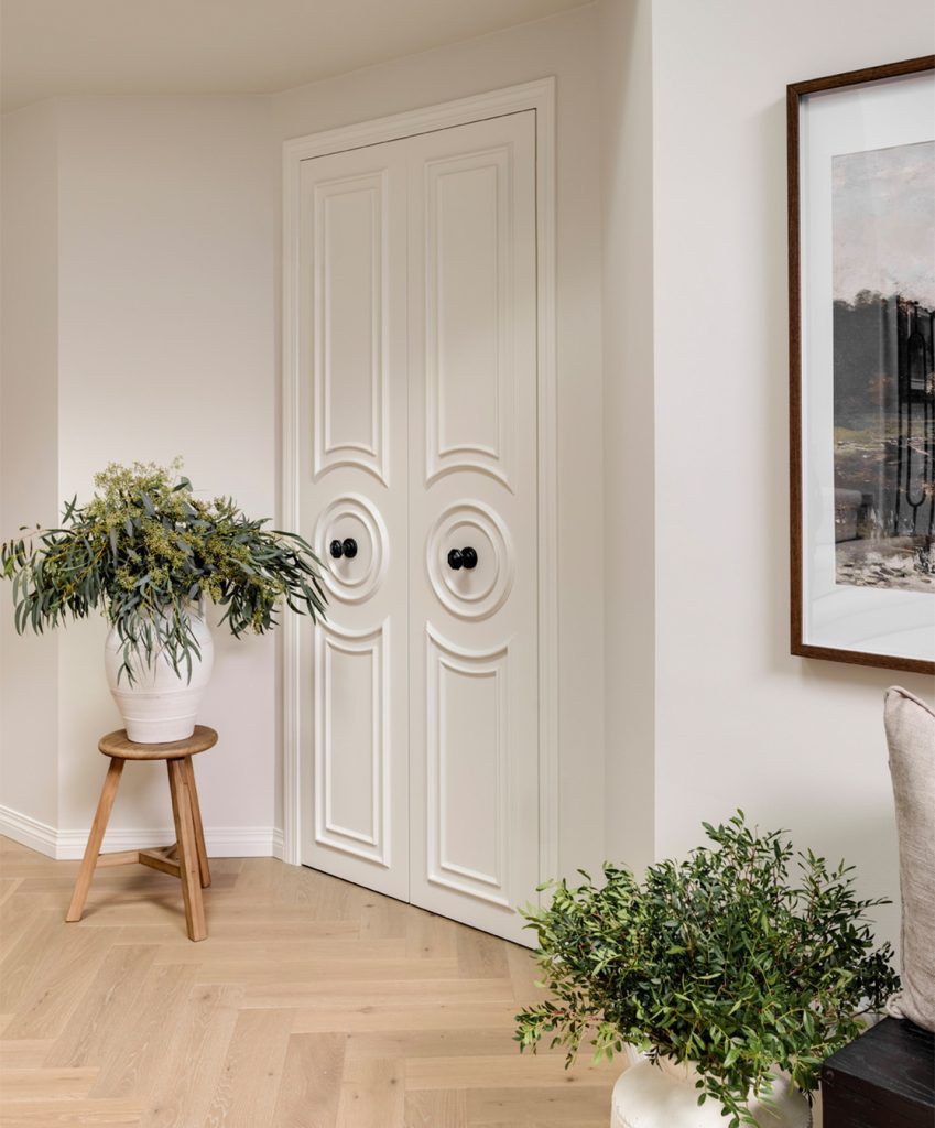 Front entrance elegant off-white closet doors.