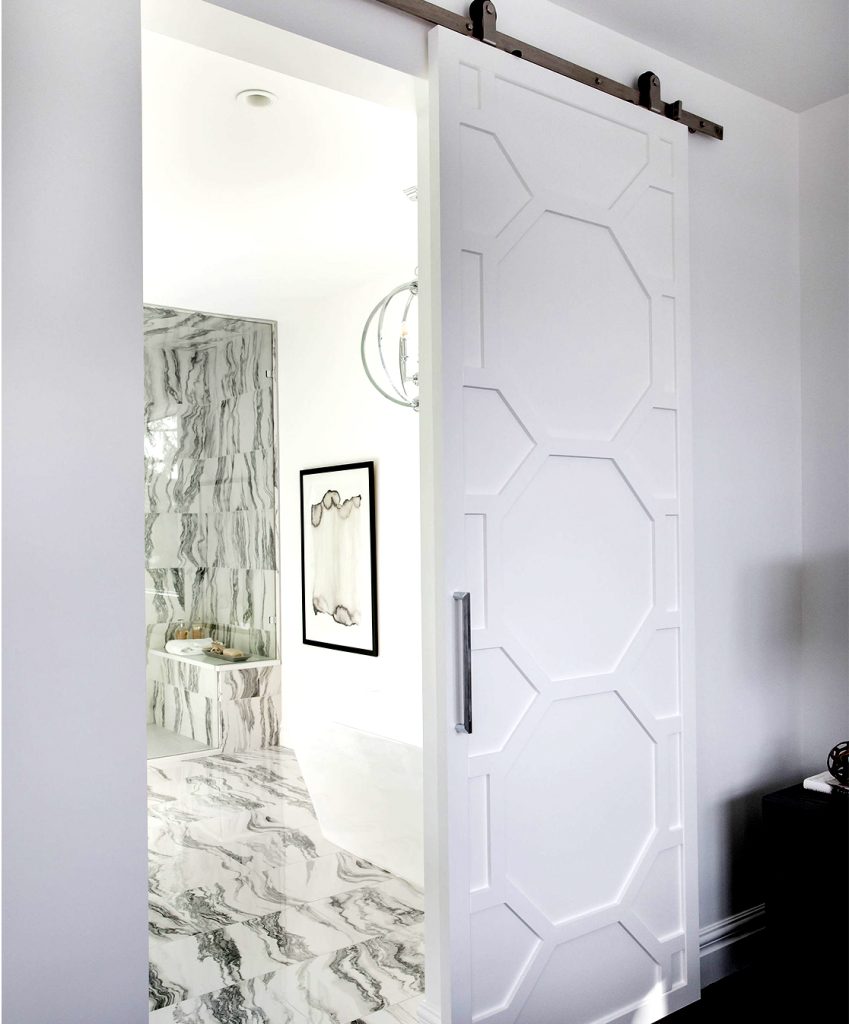 White interior barn door between and bedroom and ensuite.