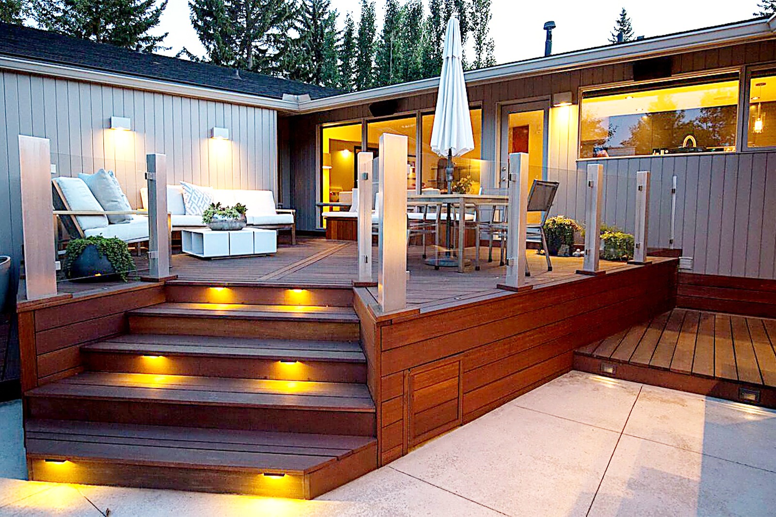 A spacious wood deck with designer lighting.